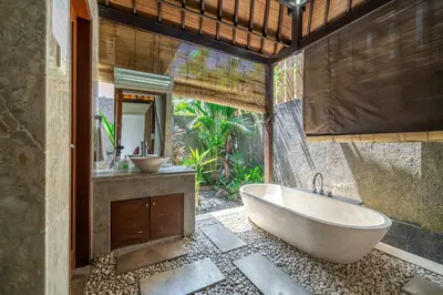 a bathroom with a tub and a sink at Beachside Villa Di Bucu in Canggu