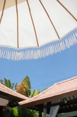 a blue and white umbrella on a roof at Beachside Villa Di Bucu in Canggu