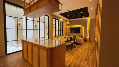 a kitchen with a counter and a dining room at Hygge Hotel and Villas Seminyak in Seminyak