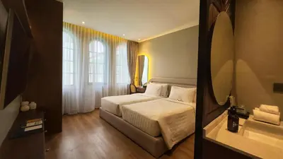 a hotel room with a bed and a window at Hygge Hotel and Villas Seminyak in Seminyak