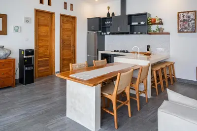 a kitchen with a table and some chairs at Villa Mailaku Seminyak in Seminyak