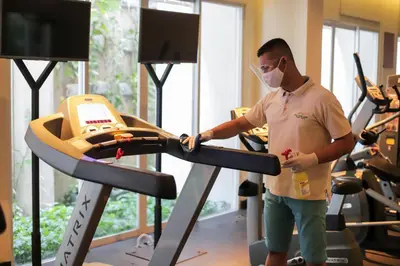 a man in a mask on a treadmill in a gym at Bali Paragon Resort Hotel in Jimbaran