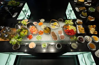 a table with a bunch of different types of food at Bali Paragon Resort Hotel in Jimbaran