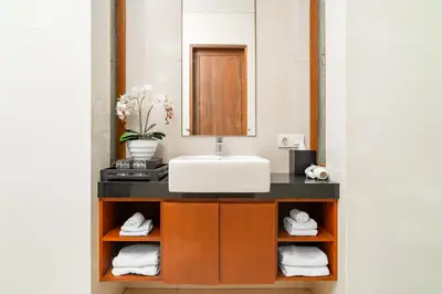 a bathroom with a sink and a mirror at Bale Gede Luxury Villas by Moria in Canggu