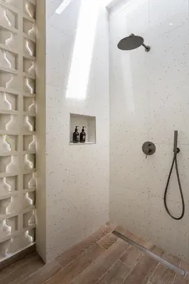 a bathroom with a shower in a room with white walls at Villa Oasia 1 Seminyak in Seminyak