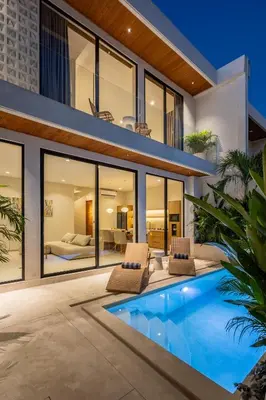 an exterior view of a house with a swimming pool at Villa Oasia 1 Seminyak in Seminyak