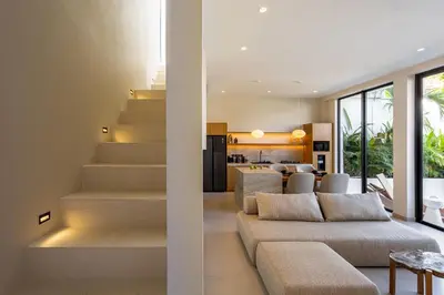 a living room with stairs leading to a kitchen at Villa Oasia 1 Seminyak in Seminyak