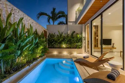 an indoor pool with plants in a house at Villa Oasia 1 Seminyak in Seminyak