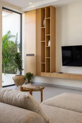 a living room with a couch and a tv and a table at Villa Oasia 2 Seminyak in Seminyak
