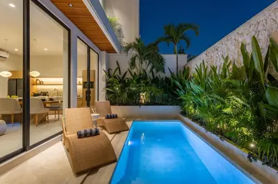 an indoor swimming pool in a house with a patio at Villa Oasia 2 Seminyak in Seminyak