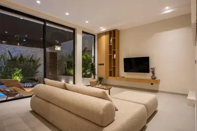a living room with a couch and a tv at Villa Oasia 2 Seminyak in Seminyak