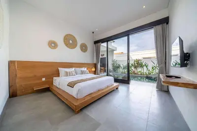 a bedroom with a large bed and a large window at Peaceful 2BR Pool Villa in Kerobokan - V2 in Kerobokan
