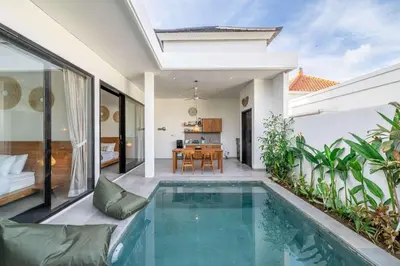 a villa with a swimming pool and a dining room at Peaceful 2BR Pool Villa in Kerobokan - V2 in Kerobokan
