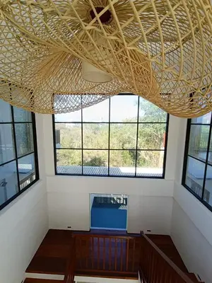 a room with a large ceiling with windows at SummerVille Nusa Dua by REJA Villas in Nusa Dua
