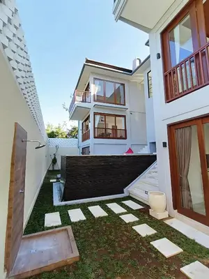 a house with a lawn in front of it at SummerVille Nusa Dua by REJA Villas in Nusa Dua