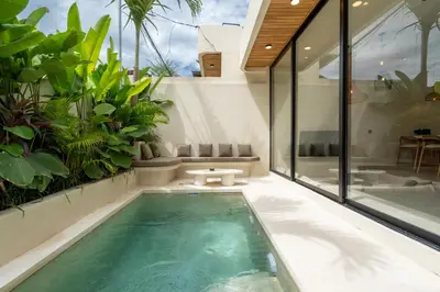 a swimming pool in a house with plants at Villa Grace&Glory-2 bedroom villa near Canggu in Kerobokan