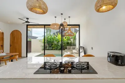 a kitchen and dining room with a table and chairs at Villa Grace&Glory-2 bedroom villa near Canggu in Kerobokan