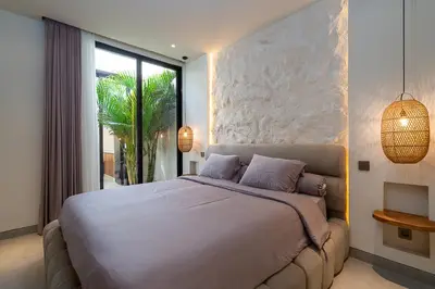 a bedroom with a large bed and a large window at Villa Grace&Glory-2 bedroom villa near Canggu in Kerobokan