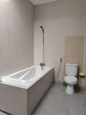 a bathroom with a bath tub and a toilet at Villa LYM BALI 3br with private pool in Legian