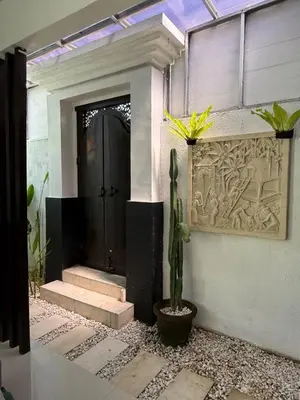 a black door with a cactus in front of it at Villa LYM BALI 3br with private pool in Legian