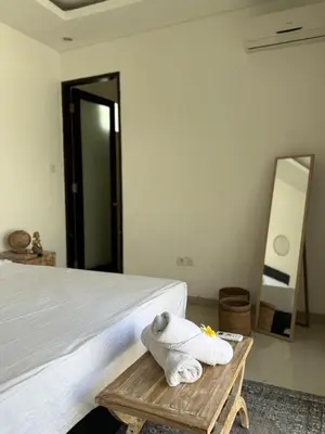 a bedroom with a bed with towels on a table at Villa LYM BALI 3br with private pool in Legian