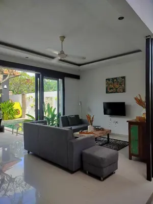 a living room with a couch and a tv at Villa LYM BALI 3br with private pool in Legian