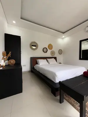 a bedroom with a large bed and a table at Villa LYM BALI 3br with private pool in Legian