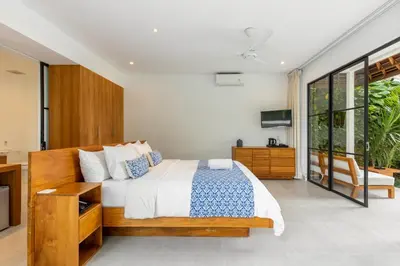 a bedroom with a bed and a large window at Stunning Garden Room with Private Pool at Anwa Bali in Canggu