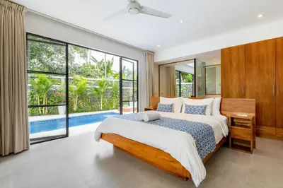 a bedroom with a bed and a large window at Stunning Garden Room with Private Pool at Anwa Bali in Canggu