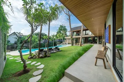 an exterior view of a house with a yard with grass at The Riverfront 5BR Luxury Villa Near the Beach in Canggu
