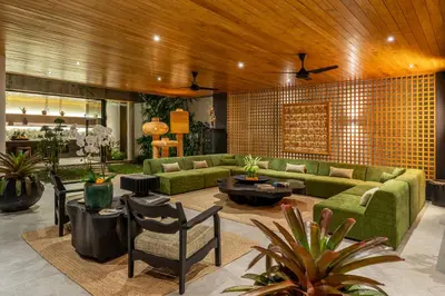 a living room with a green couch and chairs at The Riverfront 5BR Luxury Villa Near the Beach in Canggu