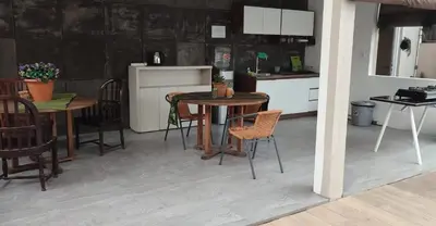 a kitchen and dining room with tables and chairs at The Tanjung Bidadari Seminyak in Seminyak