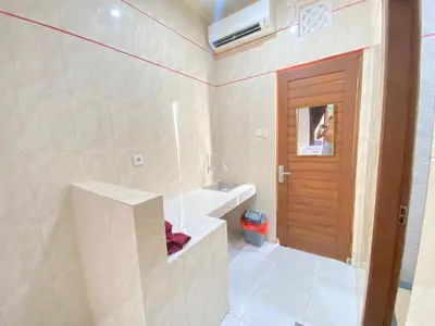 a bathroom with a sink and a bath tub at SG Hotel - 2 Minutes to the Beach By Micky Studio 1 in Legian