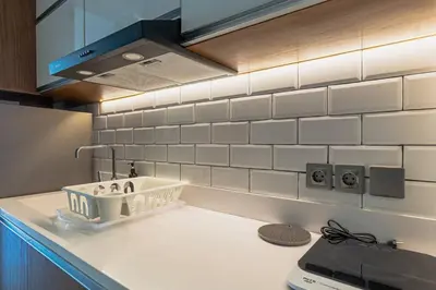 a kitchen with a sink and a counter top at LOI Mansion Managed by ARM One Hundred in Seminyak