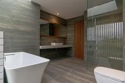 a bathroom with a white toilet and a sink at LOI Mansion Managed by ARM One Hundred in Seminyak