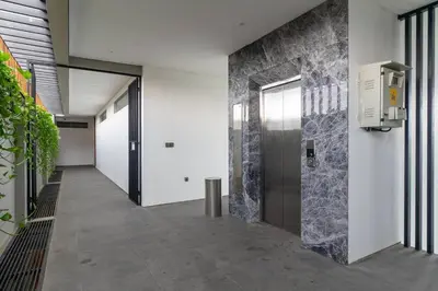 a hallway of a building with a elevator at LOI Mansion Managed by ARM One Hundred in Seminyak