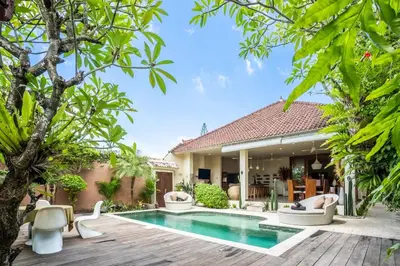 a villa with a swimming pool and a house at Villa CC- Cosy 2bdrs villa - enclosed and open living area in Seminyak