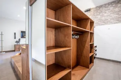 a closet with wooden shelves in a room at Villa CC- Cosy 2bdrs villa - enclosed and open living area in Seminyak