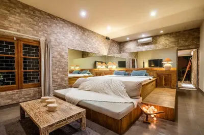 a bedroom with a large bed and a table at Villa CC- Cosy 2bdrs villa - enclosed and open living area in Seminyak