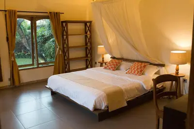 a bedroom with a bed with a canopy and a window at Two bedroom Villa in a beautyful tropical garden in Seminyak