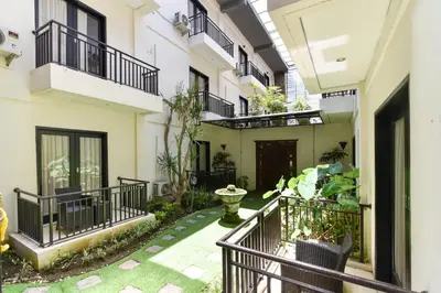 a courtyard of a building with balconies and plants at RedDoorz Plus near Mall Bali Galeria 2 in Denpasar