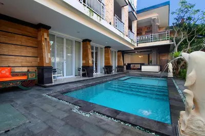 a swimming pool in the backyard of a house at Lotus Tirta Seminyak in Seminyak