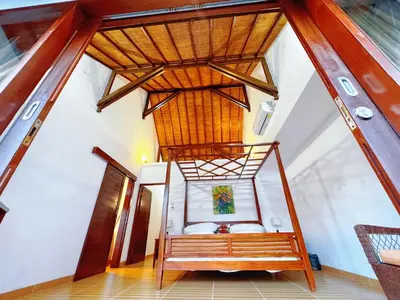 a room with a bed and a wooden ceiling at Brady's 3 bedrooms Villa Center of Sanur in Sanur