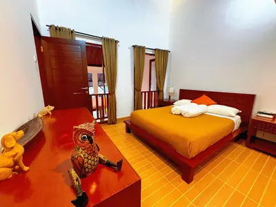 a bedroom with a bed and a table with a stuffed owl at Brady's 3 bedrooms Villa Center of Sanur in Sanur