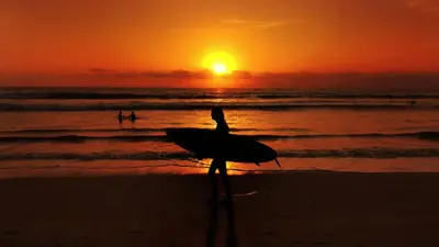 a bird standing on the beach at sunset at Ini Vie Villa Seminyak by Ini Vie Hospitality in Legian