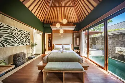 a bedroom with a bed and a swimming pool at Ini Vie Villa Seminyak by Ini Vie Hospitality in Legian