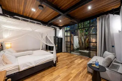 a bedroom with a bed with a mosquito net at 4 Bedrooms Brand New serenity Villa in Seminyak