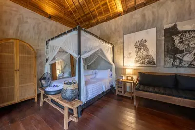 a bedroom with a canopy bed and a couch at 4 Bedrooms Brand New serenity Villa in Seminyak