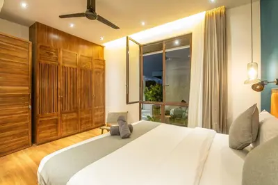 a bedroom with a large white bed and a window at Chic Modern 3BR Villa, Enclosed Living Room in Canggu
