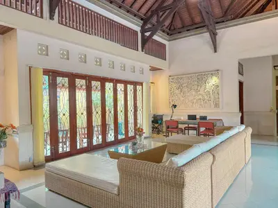 a living room with a couch and a table at Cempaka Villa in Pesanggaran